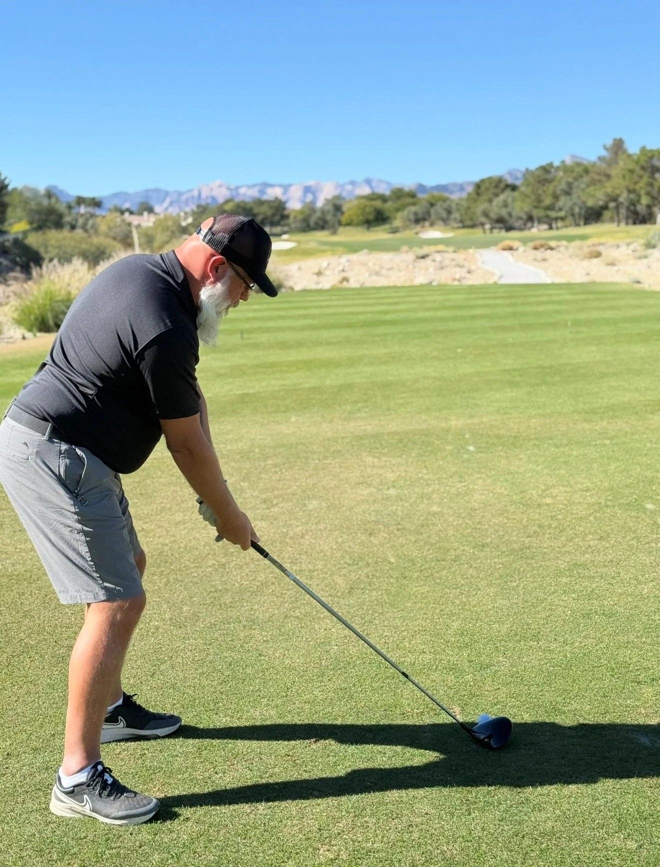 A golfer teeing off at the GGMF tournament