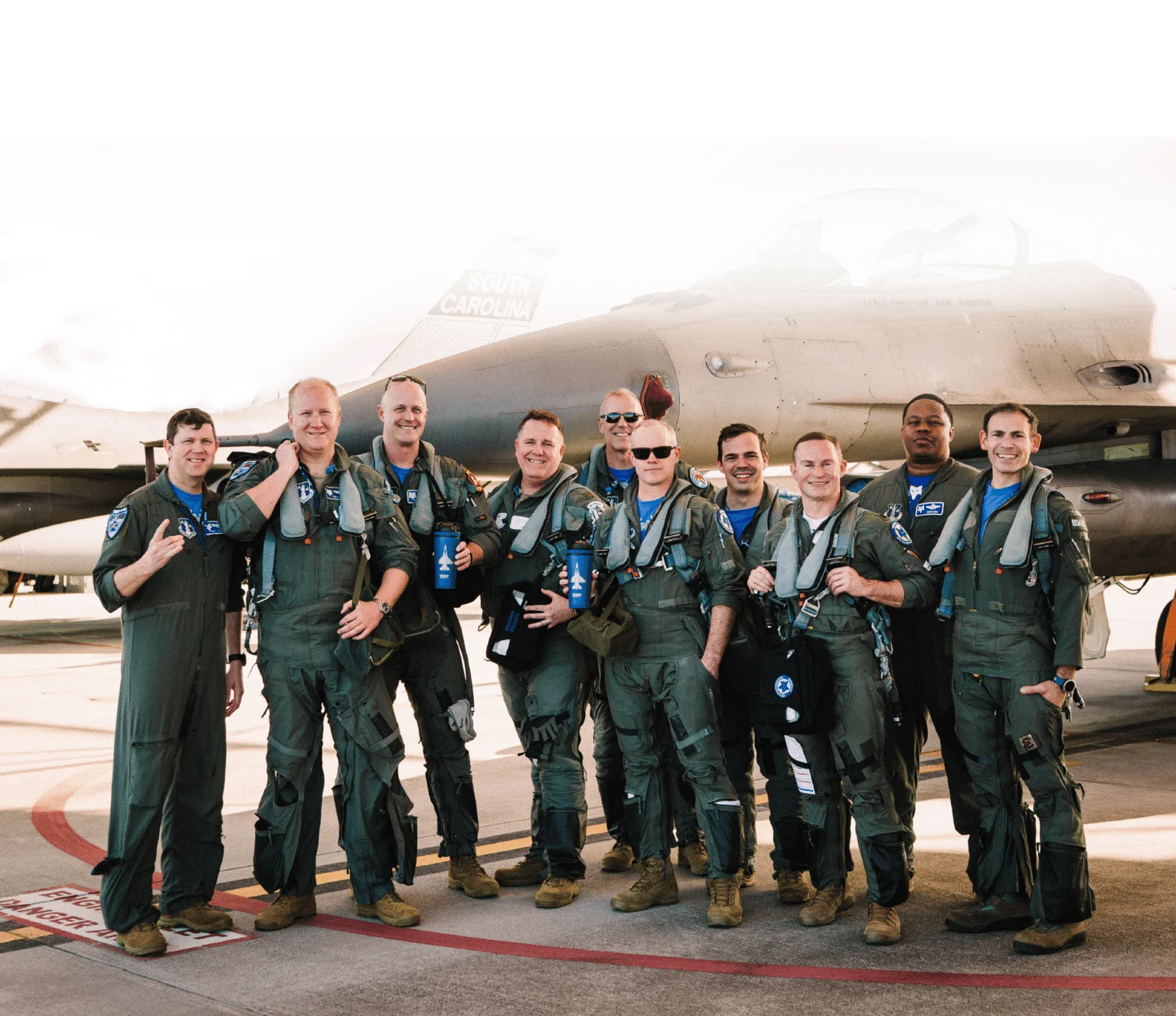 Major Garin’s fighter squadron in front of an F-16